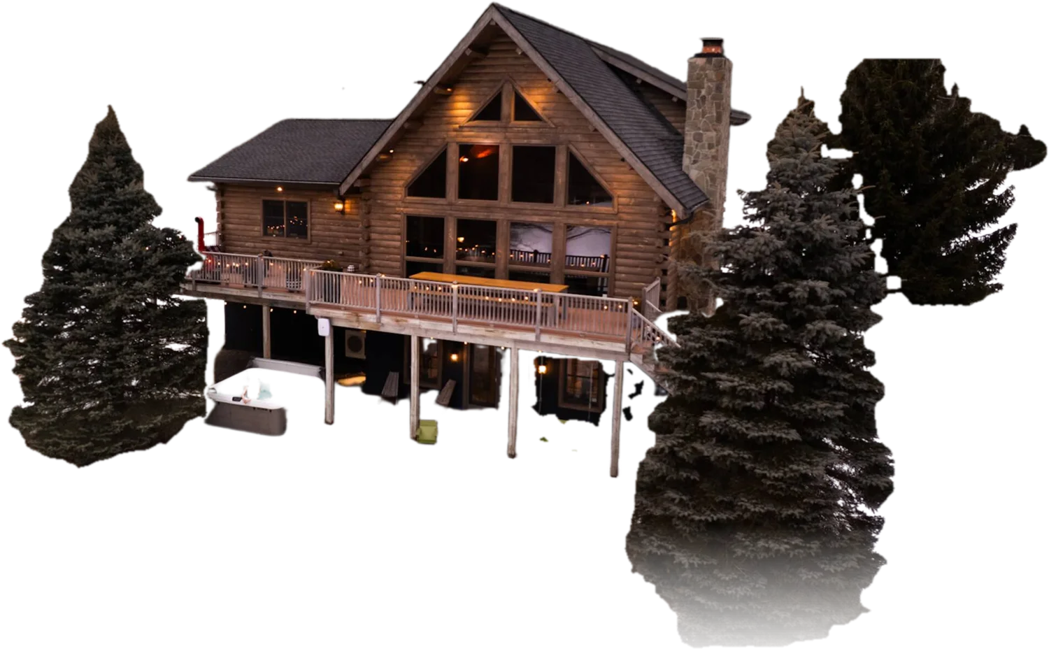 Le Chalet on a winter evening, windows and deck lights glowing