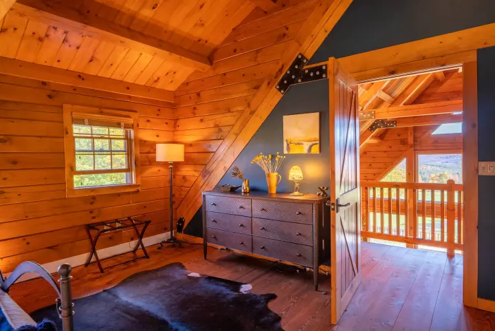 The door opens to the landing with panoramic views outside and down into the living room.