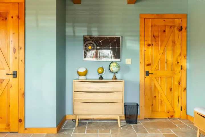 This room has a space and planet theme and is loved by both kids and adults. The dresser, built-in closet and storage bench provide space for your luggage.