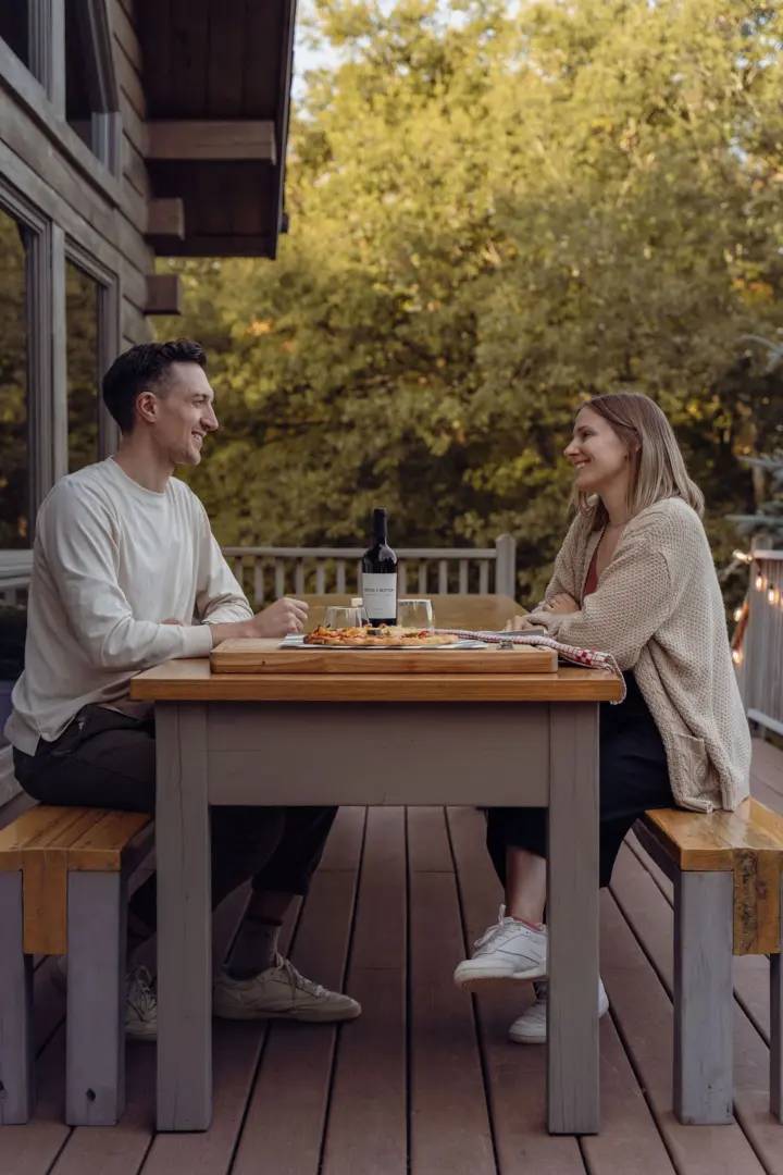 Dinner is served at the large "beer garden" style table with benches in the front (seats 12)