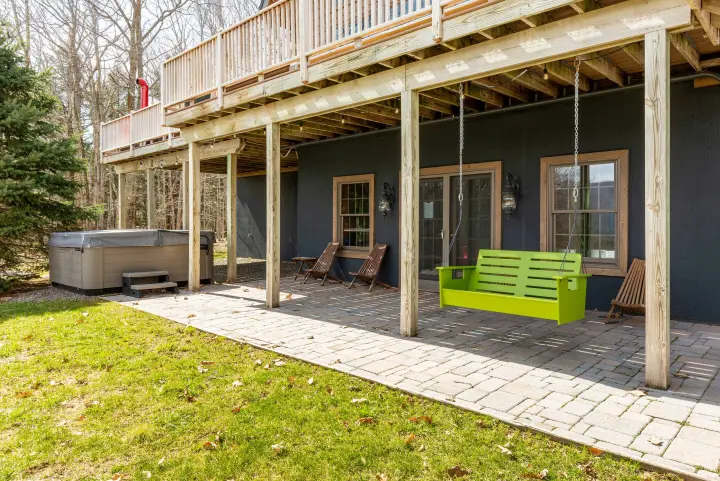 The lower front patio houses the hot tub and extra seating to enjoy the view. Relax on the porch swing after a hike or enjoy the view with your morning coffee.