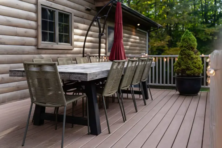 Back deck with dining table for 10. Enjoy breakfast or lunch in the shade of our large umbrella in the summer - at night the LED lights under the umbrella provide a nice cozy glow.