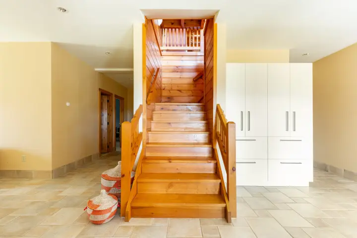 The stairs that connect the lower and main floors. The large closet is full of board games, children books and more toys.
