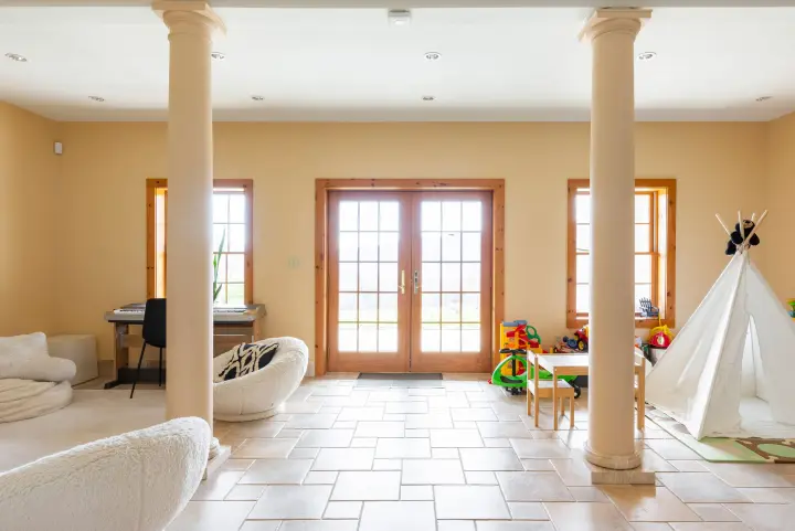 The lower level floor is a walk-out basement with high ceilings and french doors that go to the hot tub. Here you find a lounge area, kids play space, office and entertainment room.