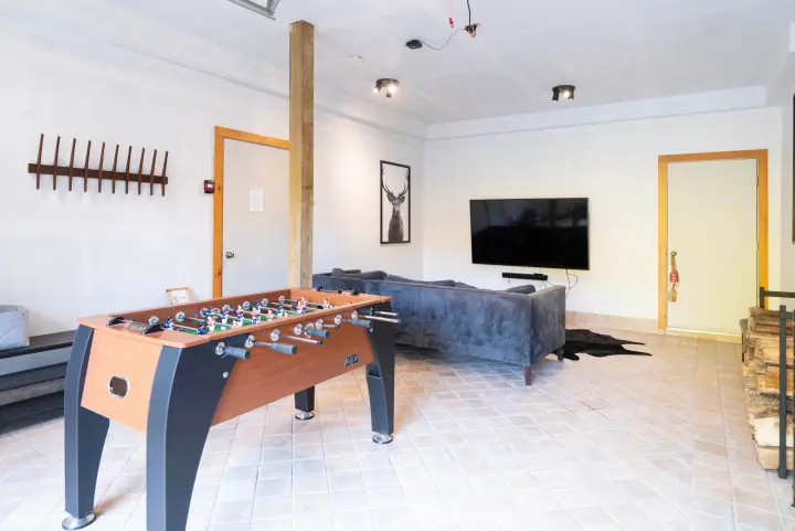 Entertainment room with a new Kick Legend 55" Foosball table and a 75" TV with Sonos soundbar. The best place to unwind after a day of skiing or hiking (after the hot tub that is!).