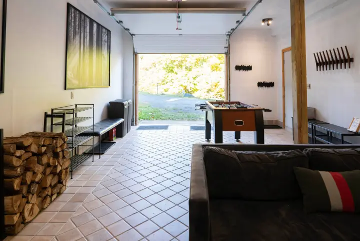 Surprise, this is also the garage where you will enter the house with a code. There are hangers for your coats and storage for your shoes and boots. You also find extra firewood here.